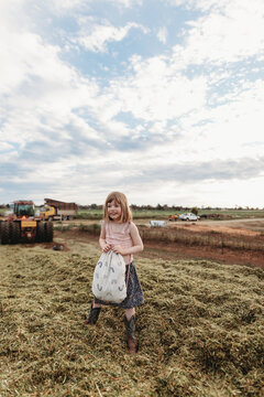 girl playing on silage stack