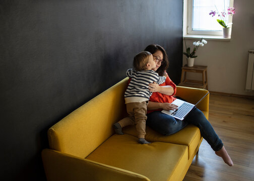 Kid Playing While Her Mom Working At Home