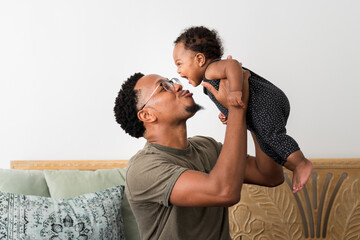 Father holding up his daughter