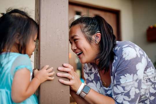 Deaf Asian mom playing peekaboo 