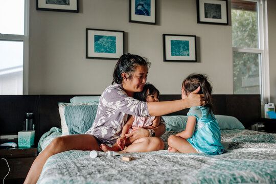 Sick girls with deaf mom on bed