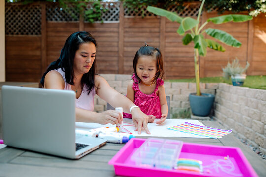 Asian mom teaches daughter how to draw 