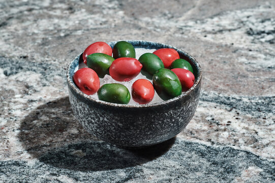 Naklejki fresh olives on a plate with ice in a ceramic plate on a stone background