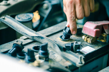 Check the battery  system, professional technicians, working, checking the condition of the car, repairing the damaged engine.