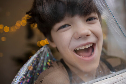 Cute, little boy looking through the window 