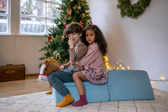 Two kids playing at the Christmas time at home