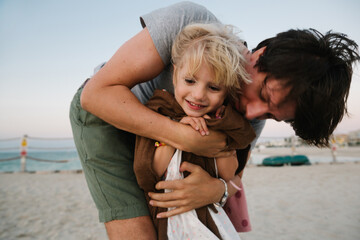 A girl with her father on the beach