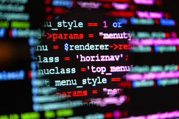 Obraz premium Software code on a monitor screen with a magnifying glass