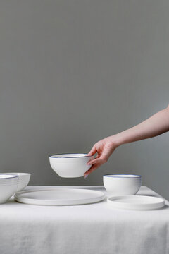 Woman hands serving porcelain bowl 