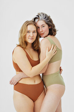 two plus size women models in lingerie hugging