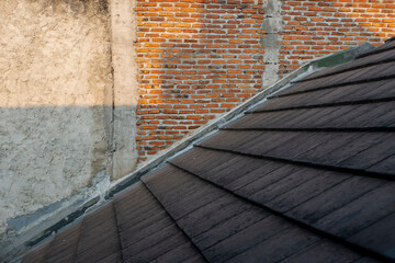 the meeting of the tile with the brick wall