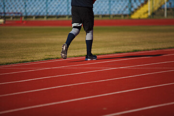 Fototapeta premium Athlete runs on a treadmill at the stadium