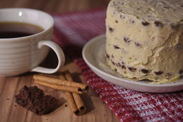Cinnamon sticks, brownie slice cake, and a cup of coffee.