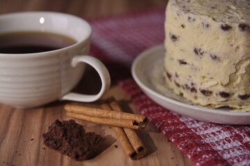 Cinnamon sticks, brownie slice cake, and a cup of coffee.