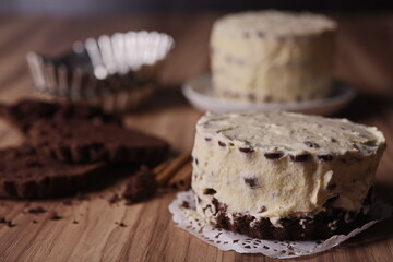 Brownie slices with buttercream and cinnamon sticks on the table.