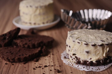 Brownie slices with buttercream and cinnamon sticks on the table.