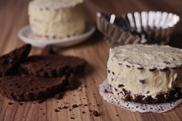 Brownie slices with buttercream and cinnamon sticks on the table.