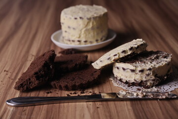Brownie slices, cream cake, and a knife on the table.
