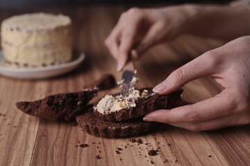 Spread the buttercream on the brownie slices to form the cake.