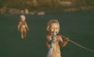 Portrait of a playing child girl on the beach