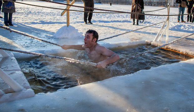 A man ice swimming during a religious tradition in Russia. 