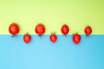 Still life with red ripe tomatoes on a colored background