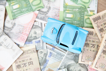 Car model on a lot of foreign banknotes
