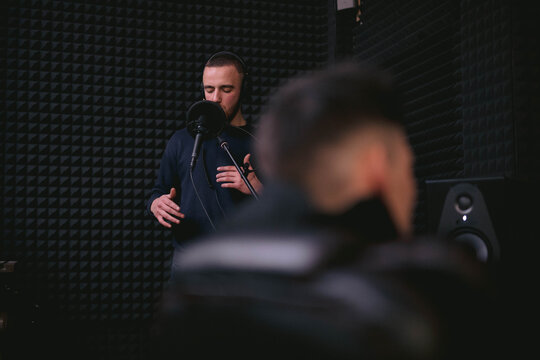 Man creating music in recording studio 