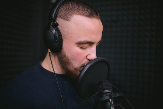 Songwriter and professional musician performing songs in music studio 