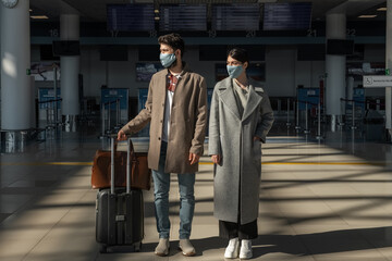 Man and woman waiting for flight during pandemic