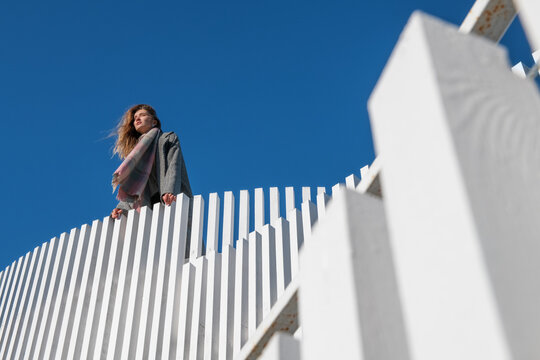 Young woman enjoying windy day on terrace