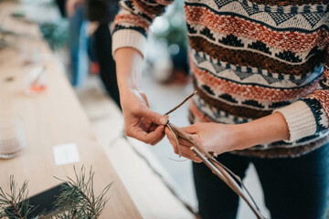 Girl making a winter wreath with dried branches