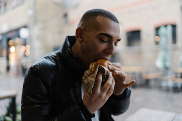 Man Eating a Hambburger Outdoor in Camden Town