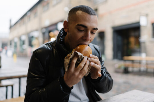 Man Eating a Hambburger Outdoor in Camden Town