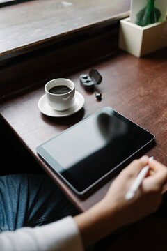 Man Drinking a Coffee and Working from a Coffee Shop
