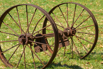 Fototapeta na wymiar Rusty iron wheels in field at Whitaker Woods in Connecticut.