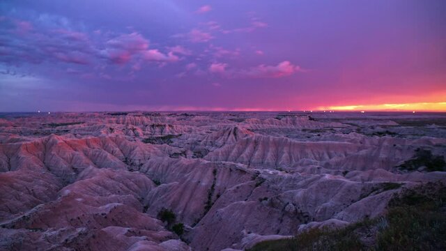 Colorful sunset timelapse with lighting on the horizon over the Badlands in South Dakota, repeating.