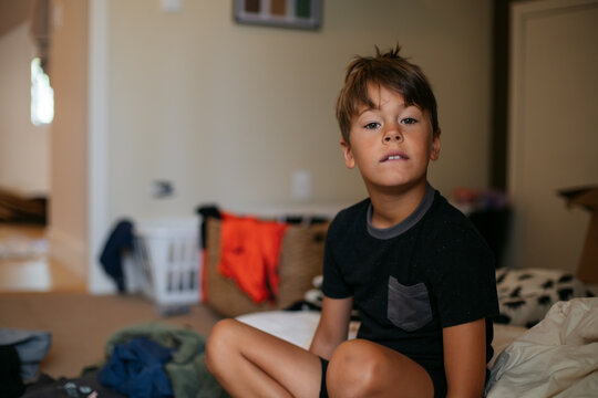 Young boy inside home and bored