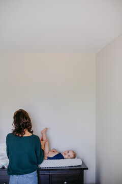 Parent changing baby's diaper
