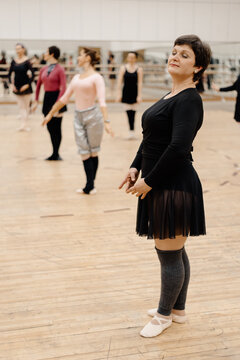 Graceful middle aged ballet dancers in spacious hall
