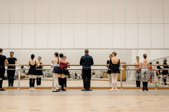 Company of ballet dancer during rehearsal in class
