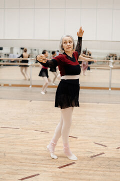 mature woman dancing in ballet school
