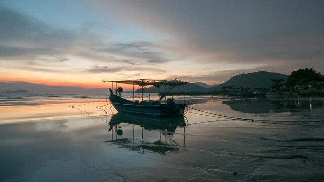 Timelapse view reflection of boat during low tide at Permatang Damar Laut, Penang