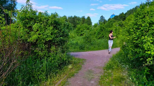 Frightened female runs from maniac in forest park. Threat and fear, she asks for help