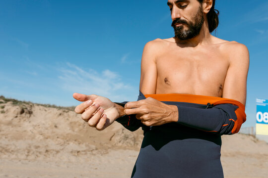 man in diving suit warming up