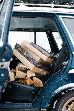 Classic Car With Dog, Christmas Tree, And Presents Inside Of The Car