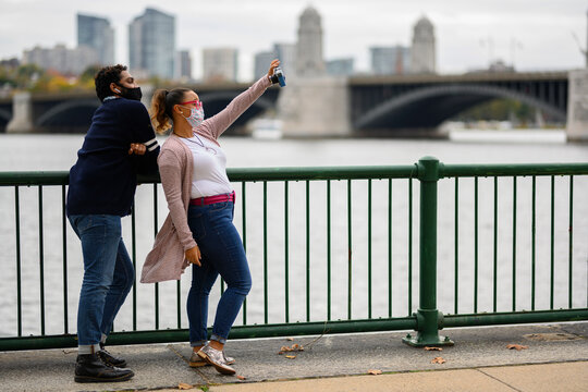 Young African American Couple Taking selfie with film camera with masks