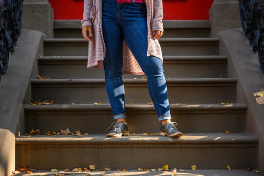 Plus Size Woman Standing on Steps at urban Brownstone 