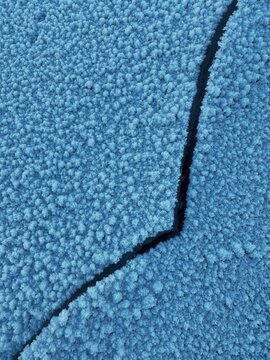 Winter pattern, snow-covered ice with a crack