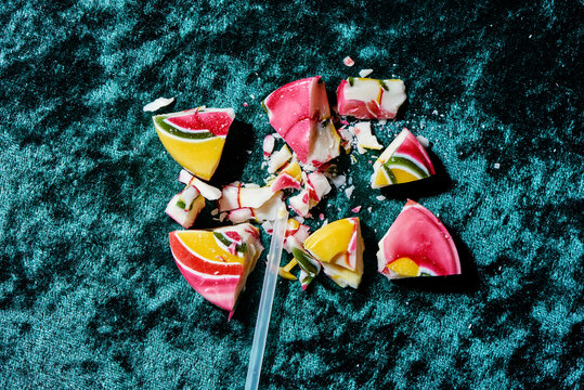 broken lollipop on a blue velvet fabric